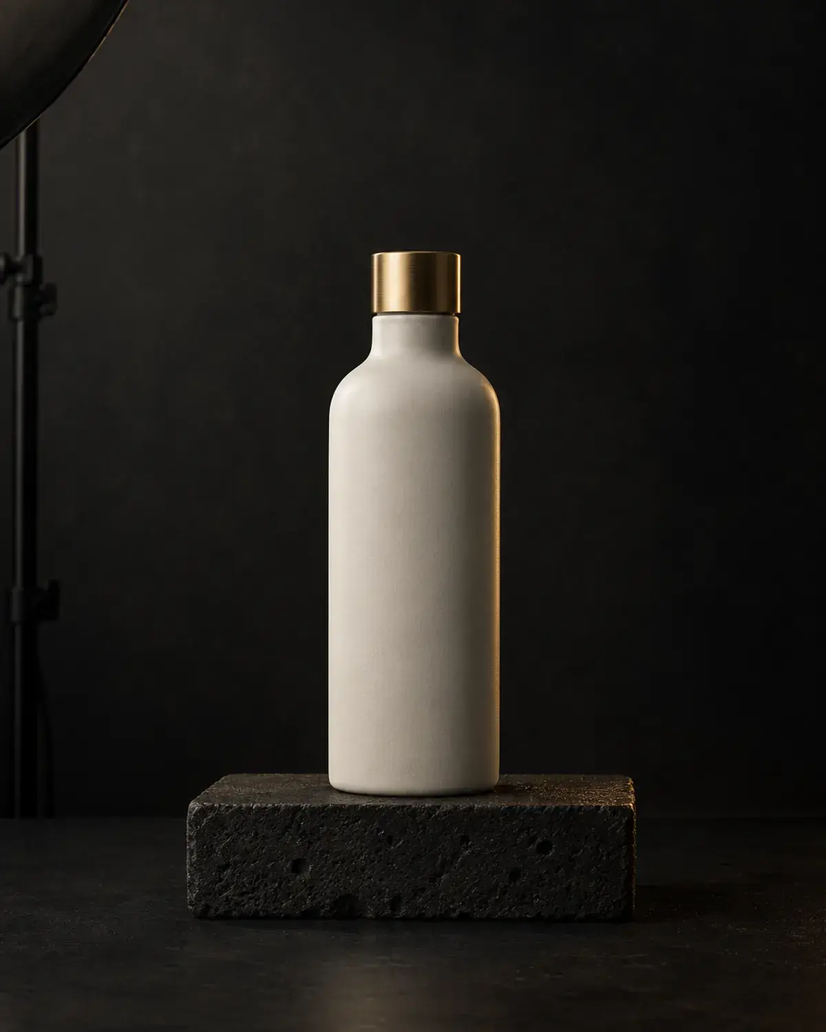 An unbranded product on a dark stone plinth, lit by a single studio light.